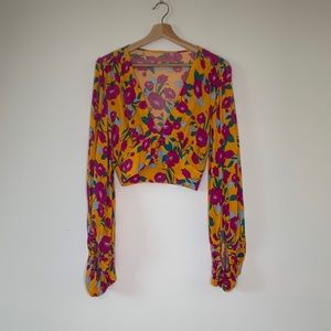 Plunge neck blouse with bell sleeves. Floral print